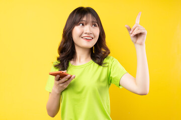 Young girl using phone with cheerful expression on background