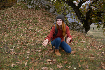 woman tourist with backpack in autumn forest travel nature