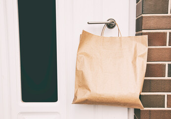 The courier left the order in paper package on the handle of the door