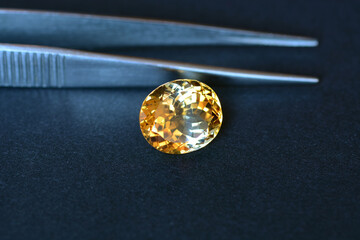 Natural yellow uneven distributed color in crystal massif of oval faceted loose citrine gemstone...