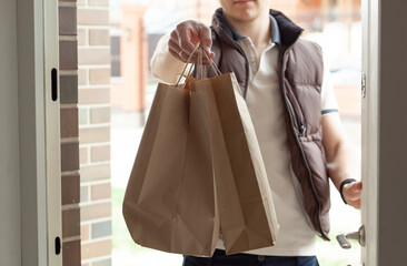 The courier delivers the order to the customer at the door at his house