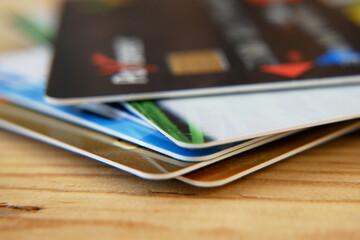 many bank's card and prepaid payment card on wooden background