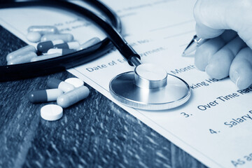pills and stethoscope and hand signs the medical Insurance, Insurance agent holding pen medical...
