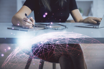 Double exposure of woman hands typing on computer and social network theme hologram drawing. People...