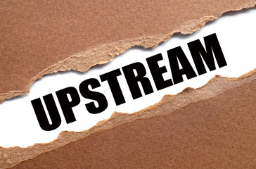 UPSTREAM. text inside torn paper. white sheet with black font.