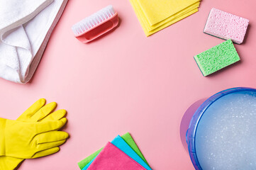 House cleaning product and bucket, pail, container with foam on pink background, copy space. Flat...