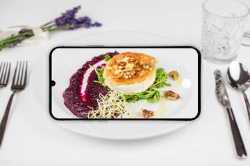 Taking a picture of grilled cheese with smartphone isolated