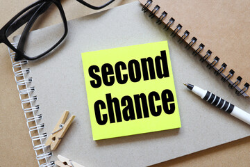 SECOND CHANGE. text on a bright sticker on a craft background.