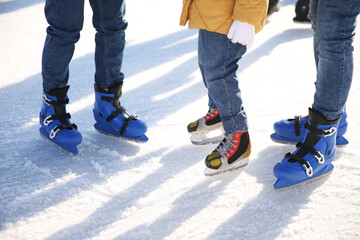 Family at outdoor ice skating rink, closeup