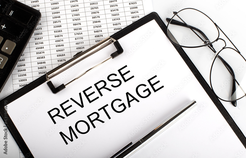 Aufkleber paper with text reverse mortgage on the table on chart