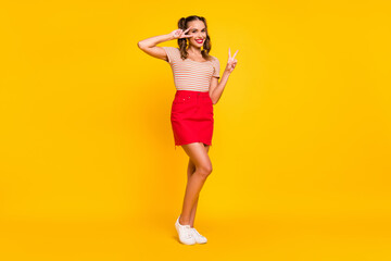 Full length photo of girl two hands show v-sign wear striped shirt mini skirt shoes isolated yellow color background