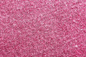Pink wool sweater fabric. Closeup textile texture. Apparel clothes. Casual wear. Knit pattern. Warm winter fiber material. Fuchsia color cotton background.