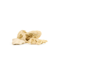 Small beige stones on isolated white background with copy space. Background for cosmetic products. Stone podium. Front view