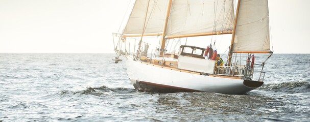 Old expensive vintage two-masted sailboat (yawl) close-up, sailing in an open sea during the storm....