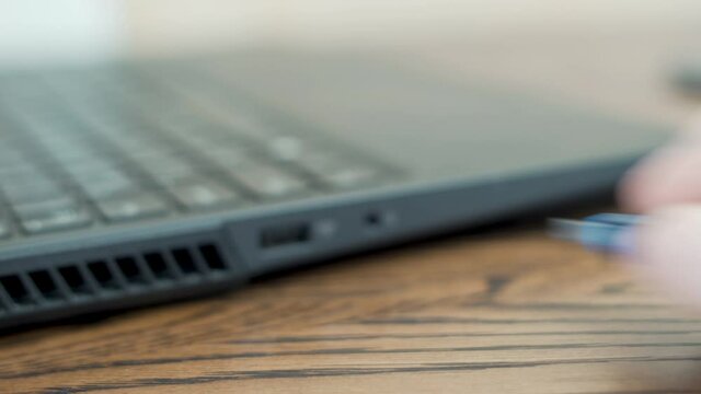 The Process Of Disconnecting, Sticking Out the Flash Memory Card from the Laptop. The Hand Disconnects, Sticks out the USB Flash Drive from the USB Port of the Laptop. Close-up of a flash drive