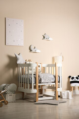 Cute baby room interior with modern crib and toys