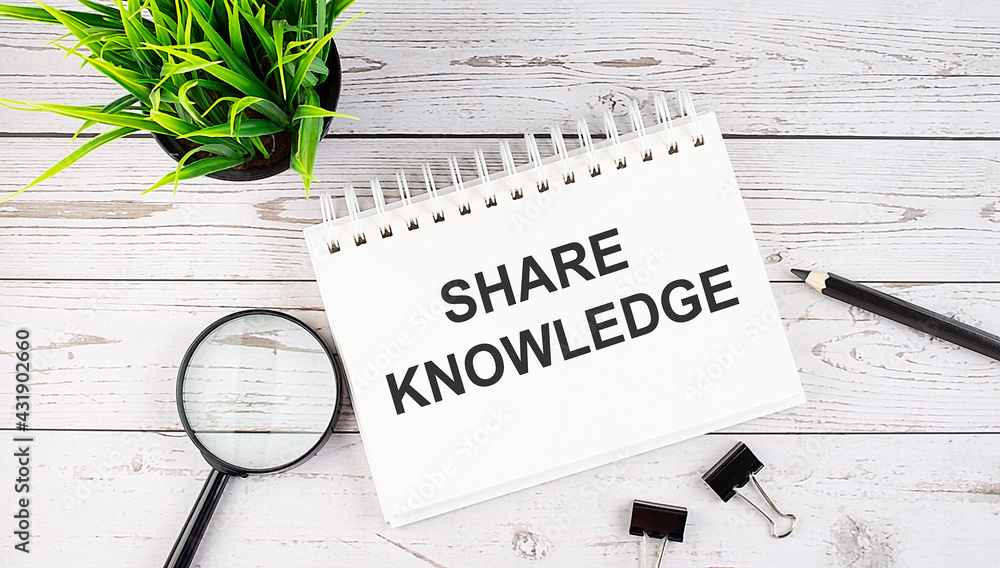 Poster share knowledge text concept write on notebook with office tools on wooden background