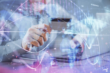 Double exposure of man hands holding a credit card and internet business theme drawing. Digital fintech and E-commerce concept.