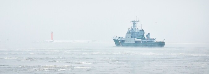 Coast guard ship sailing during the storm. Winter. Fog, waves, rough weather. Baltic sea. Transportation, nautical vessel, international security, global communications, border control, customs © Alex Stemmer