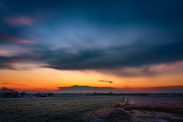 a cumulonimbus storm cloud over the fields and convective rainfall.