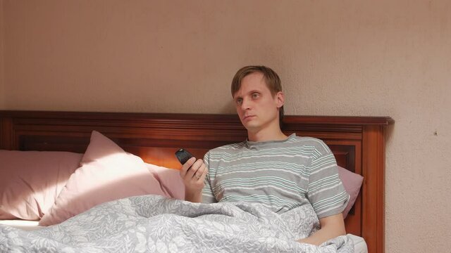 Man watching TV time lapse on bed falls asleep talking on the phone