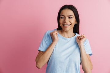 Fototapeta premium Excited hispanic woman gesturing and smiling at camera