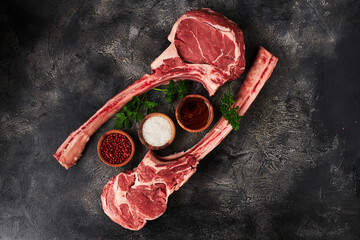 Raw tomahawk steak on wooden board