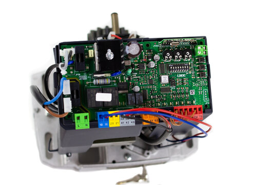 Gate Operator On Isolated White Background Close-up, Computer Microcircuits, Mechanism With Wires, Keys, Circuit Breakers, Automatic Gate Operator, Components Installed On The Motherboard