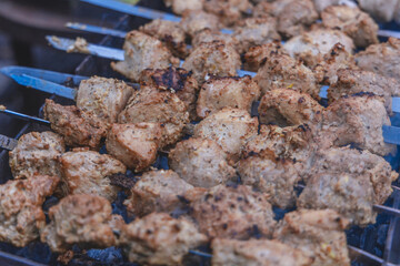 Cooking meat on coals outside. selective focus. Grilled meat background. Grilled shish kebab on the gri