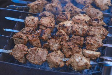 Cooking meat on coals outside. selective focus. Grilled meat background. Grilled shish kebab on the gri