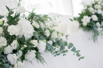 Close up of flower arrangement for wedding main table at a wedding reception.