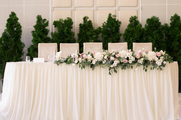 Main table at a wedding reception with beautiful fresh flowers