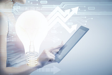 Double exposure of light bulb hologram and woman holding and using a mobile device. Idea concept.