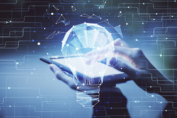 Double exposure of light bulb hologram and woman holding and using a mobile device. Idea concept.
