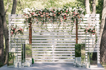 Wedding ceremony. Very beautiful and stylish wedding arch, decorated with various fresh flowers,...
