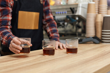 three glasses of freshly brewed coffee on wooden table