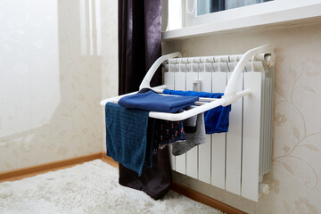 Clothes dryer. Blue clothes is fixed to dry after washing at home on battery. Idea for saving...