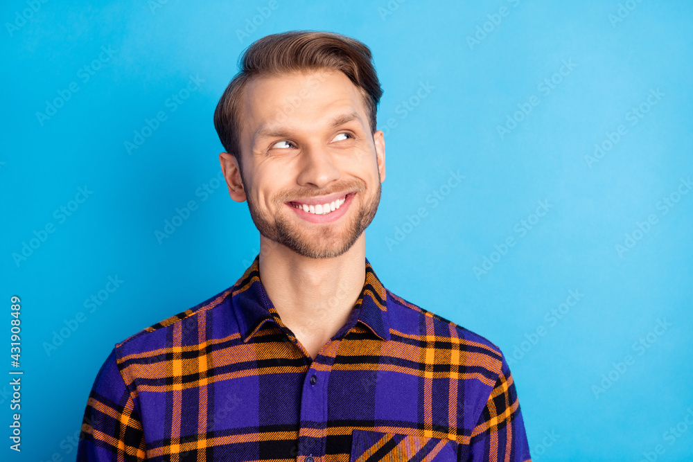 Wall mural portrait of young person look interested empty space toothy smile wear checkered isolated on blue co