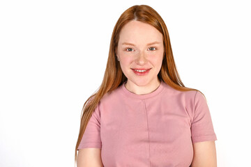 Fototapeta premium Portrait of a red-haired girl, a girl smiling on a white background