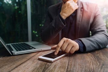 Businessman holding tablet and checking analyzing sales data growth graph chart and stock market on global networking. Business strategy, planning and digital marketing on blue background.