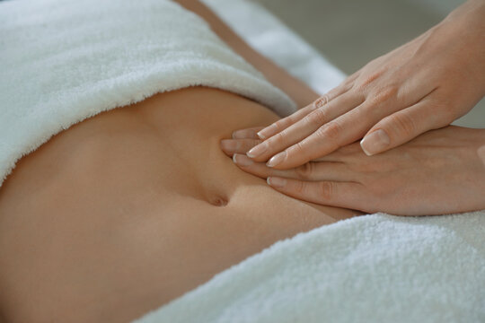 Woman receiving professional belly massage, closeup view