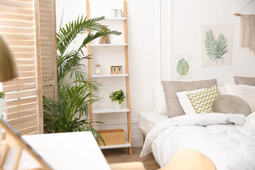 Modern bedroom with beautiful fresh house plants