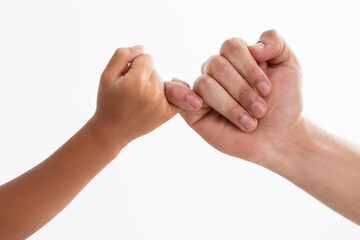 Closeup of father and daughter holding little fingers