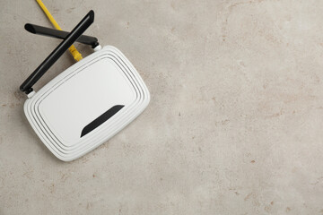 Modern Wi-Fi router on light background, top view. Space for text