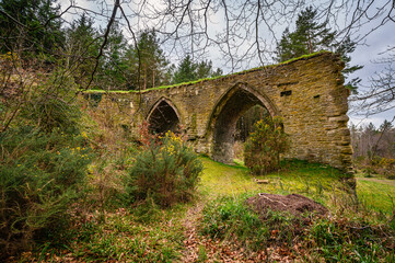 Gothic Arches of Dukesfield Mill, the remains of a lead smelting mill which was built in the 18th century, situated in woodland on the banks of Devils Water near Hexham in Northumberland