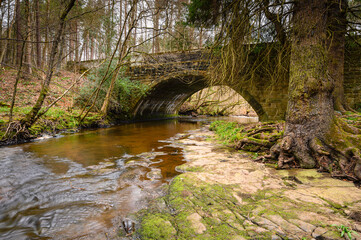 Naklejka na ściany i meble Dukesfield Mill Bridge above Devils Water, a river in Northumberland and is a tributary of the River Tyne, the confluence is between Hexham and Corbridge