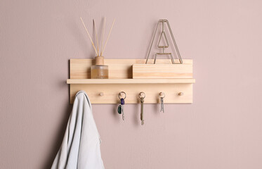 Wooden hanger for keys on color wall
