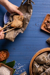 Zongzi rice dumpling top view for Dragon Boat Festival over dark black background.