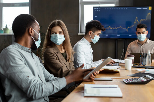 Colleagues Having Meeting In Boardroom, Working On A Project