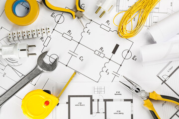 Flat lay composition with electrician's tools on house plan sheets